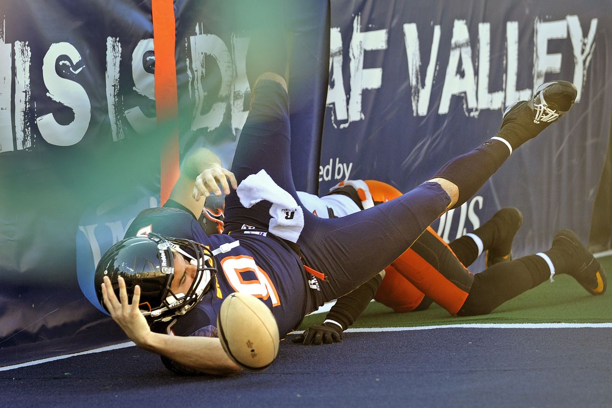 Spokane Shock quarterback Erik Meyer almost has his helmet knocked off as he dives in for a score on a scramble in the second quarter against Utah, Saturday, July 9, 2011, at Albi Stadium in Spokane, Wash. (Christopher Anderson / The Spokesman-Review)