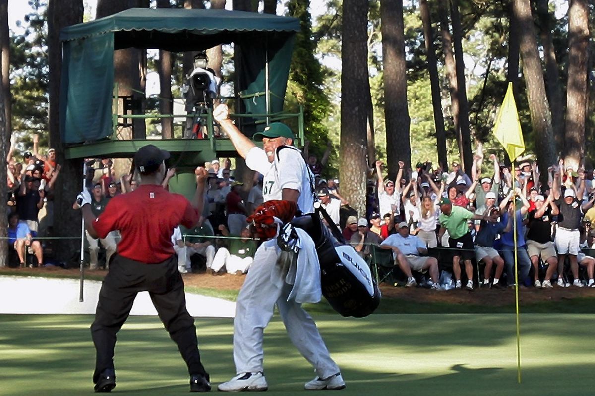 In this April 10, 2005, file photo, Tiger Woods celebrates with his caddie Steve Williams after his chip-in birdie on the 16th hole during the 2005 Masters at Augusta National Golf Club in Augusta, Ga. Jordan Spieth was so inspired by this major and that moment that it was the first shot he wanted to try when he played the Masters for the first time. (Elise Amendola / Associated Press)