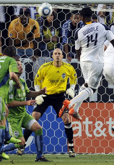 Galaxy's Edson Buddle, right, scores a goal 3-1 win over Sounders. (Associated Press)
