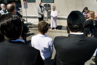 Jerry Klinger, president of the Jewish American Society for Historic Preservation, and Emily Sue Pike speak at the rededication of a plaque commemorating the state’s first Jewish temple,  on Madison Street between Third and Fourth avenues. (Colin Mulvany / The Spokesman-Review)