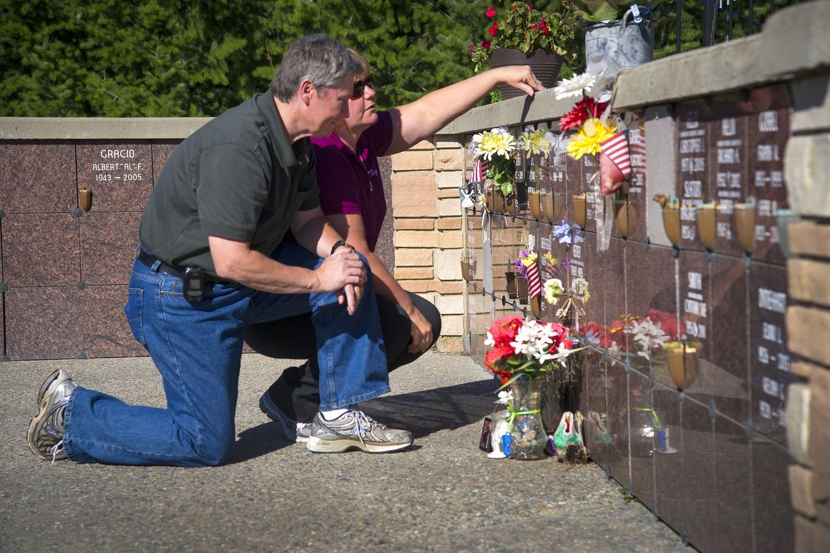 Dennis and Donna Heinen pause Thursday at a columbarium at Fairmount Memorial Park where the ashes of their son, Dylan, are interred. (Colin Mulvany)