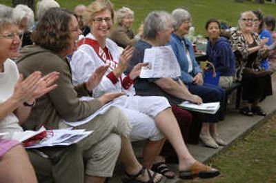 
From left, Carol Vines, Sheila Thomsen  and Mary Ann Murphy  laugh and clap after the reading of 