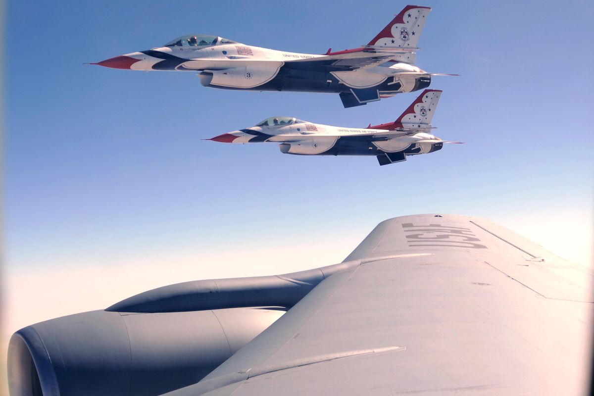 Two of the Air Force Thunderbirds demonstration team fly alongside a KC-135 tanker aircraft Thursday, Oct. 11, 2017, over the Nevada desert as each  is refueled by the tanker. Refueling smaller aircraft as they move around the United States and the world  is the key mission of the Fairchild Air Force Base tankers. The Thunderbirds were en route to an air show in Boise, Idaho this weekend. (Jesse Tinsley / The Spokesman-Review)