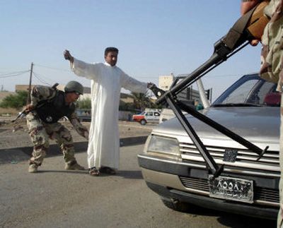 
Iraqi army soldiers check a man for weapons in Amarah on Tuesday. At least two policemen were murdered early Tuesday in the southern Iraq city. 
 (Associated Press / The Spokesman-Review)