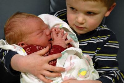 
Eli Armstrong 4, holds his new brother Owen at Sacred Heart Medical Center in Spokane on Monday. Owen was Spokane's first baby of the new year. 
 (Kathy Plonka / The Spokesman-Review)