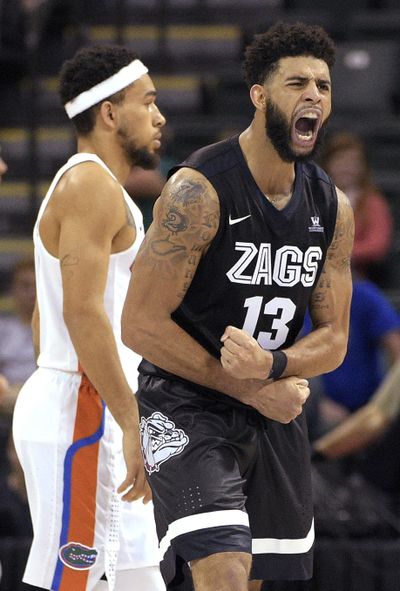 Gonzaga guard Josh Perkins (13) celebrates in front of Florida guard Chris Chiozza after a score during the second half of an NCAA college basketball game in Lake Buena Vista, Fla., Saturday, Nov. 26, 2016. Gonzaga won 77-72. (Phelan M. Ebenhack / Associated Press)