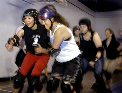 
Lilac City Rollergirl Naomie Weitz, left, blasts past a teammate during a recent practice at the Spokane YWCA. 
 (Joe Barrentine / The Spokesman-Review)