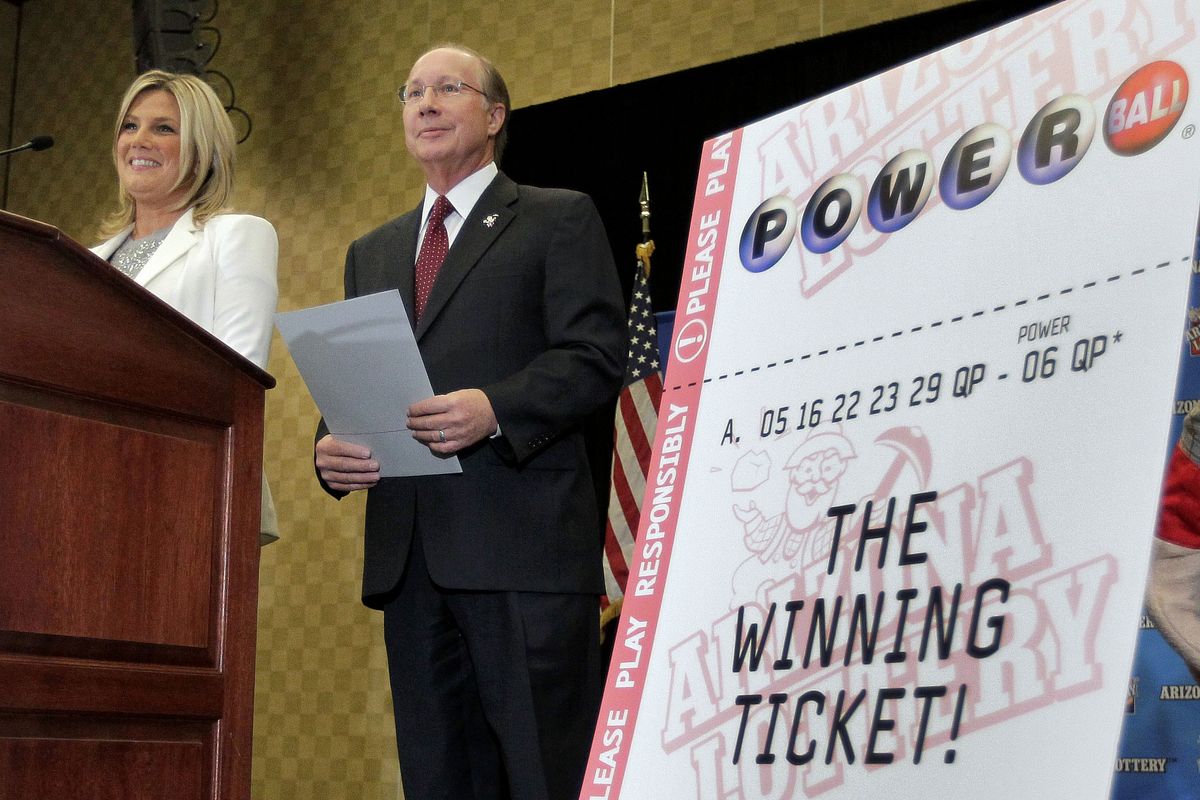Arizona Lottery Director of Budget, Products and Communications Karen Bach, left, and Arizona Lottery Executive Director Jeff Hatch-Miller stand next to an enlargement of the winning $587.5 Million Powerball ticket, Friday, Dec. 7, 2012 during a news conference in Scottsdale, Ariz. The Lottery held the news conference to announce that the Arizona Lottery Powerball jackpot winning ticket has been claimed by an unidentified Arizona man. The $587.5 million jackpot is the largest in Powerball history and will be shared by co-winners Mark and Cindy Hill from Missouri. (Matt York / Associated Press)