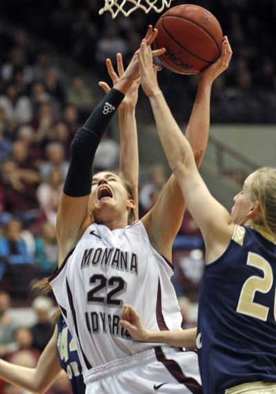 Montana forward Katie Baker goes up under the basket as Lindsay Mallon defends. (Associated Press)