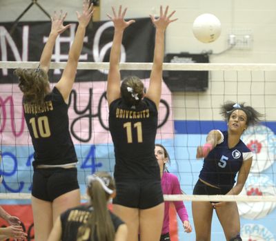 University's Brooklynn Tacke (10) and Alex Douglas (11) can't stop the well-aimed hit of Central Valley's RaSasha Montgomery, right, during the Flying Cow rivalry game Tuesday, Oct. 28, 2014 at Central Valley High School. CV won 3-1. (Jesse Tinsley / The Spokesman-Review)