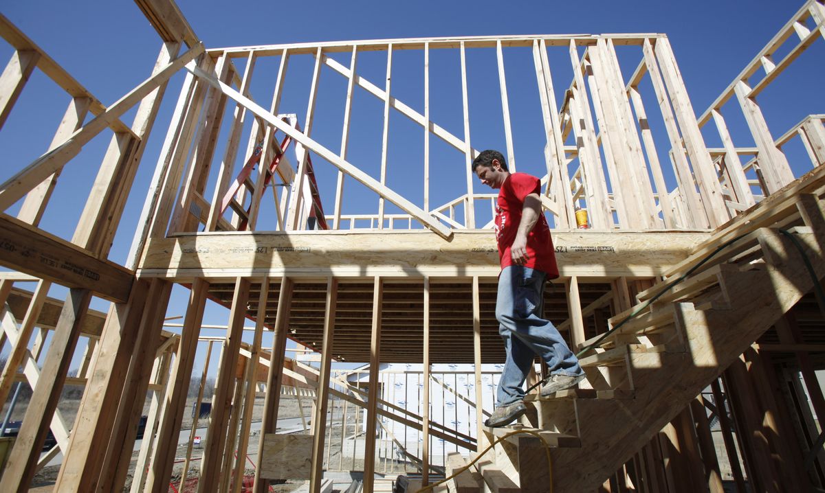 T.J. Fazio walks down a flight of stairs on a new home construction site in West Des Moines, Iowa. (Charlie Neibergall / The Spokesman-Review)
