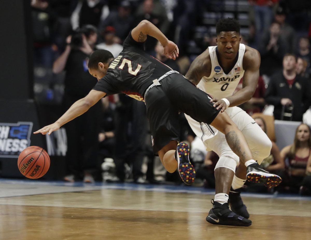 Xavier forward Tyrique Jones (0) fouls Florida State guard CJ Walker (2), during the second half of a second-round game in the NCAA college basketball tournament in Nashville, Tenn., Sunday, March 18, 2018. Florida State defeated Xavier 75-70. (Mark Humphrey / Associated Press)