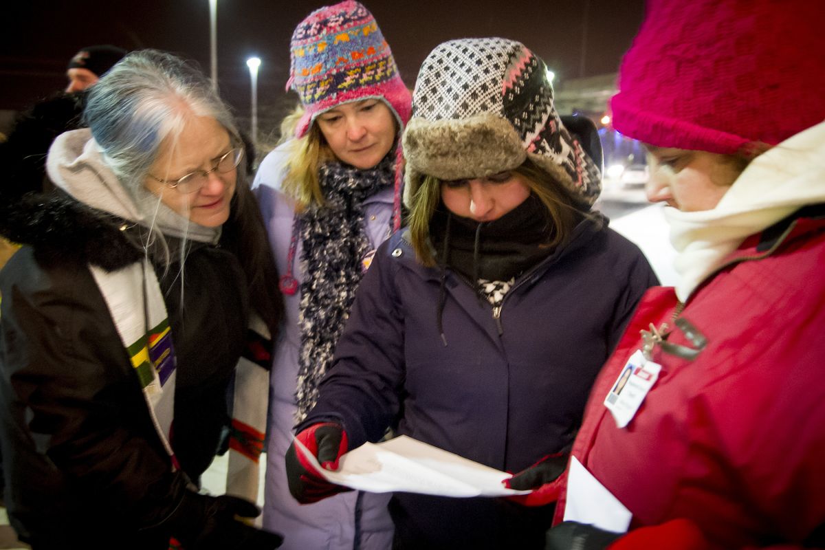 Sabrina Kimm, lead organizer with SEIU 1199NW, holds a letter telling Janeen Massaia, a Valley Hospital RN, pictured far right, not to return to work until Saturday. At least 20 employees of Valley Hospital, including nurses and technical workers, were locked out of the hospital following a one-day strike on Wednesday. (Colin Mulvany)