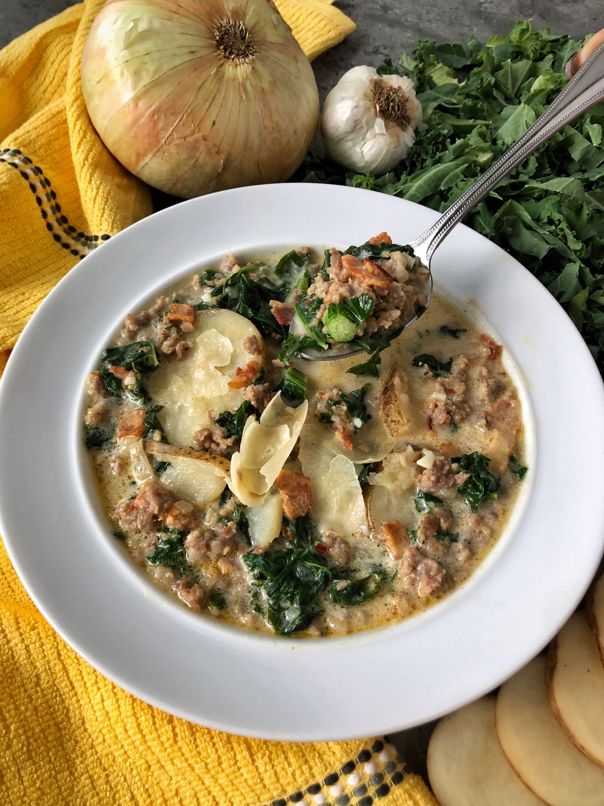 Ingredients for this zuppa toscana soup include hot Italian sausage, crisp bacon bits, tender rounds of potatoes and fresh kale.  (Audrey Alfaro/For The Spokesman-Review)