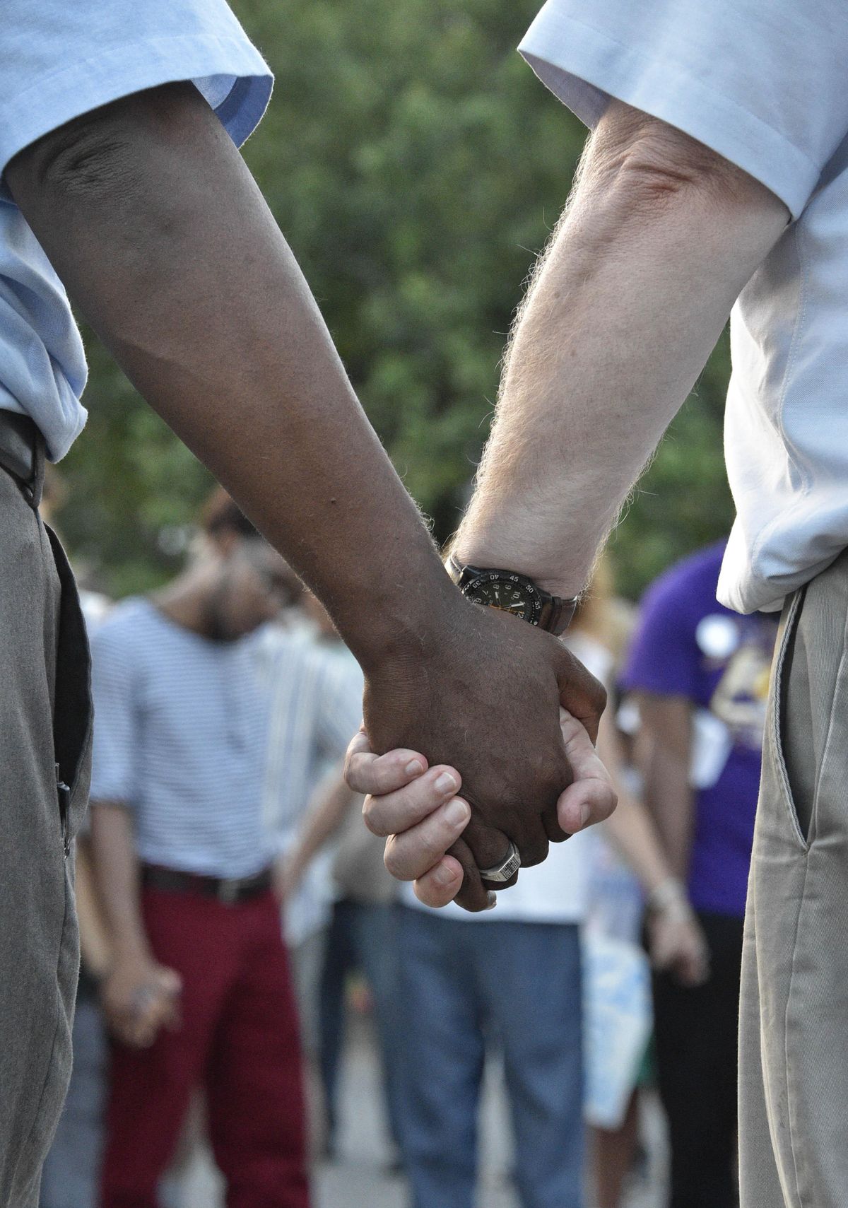People hold hands at a vigil and march to the Fallen Officer Memorial in Huntsville, Ala., on Friday. (Bob Gathany / AP)