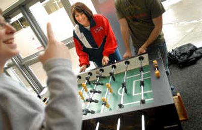 
Kathy Brainard, center, plays foosball with students at Cheney High School last week. Brainard recently won third place in the world championships of foosball in Italy. 
 (Brian Plonka / The Spokesman-Review)