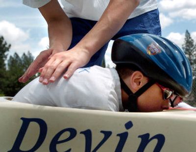 
Devin Katterfeld gets tucked into his soap box car by his older brother Chris before zooming down the hill Saturday.   
 (Amanda Smith / The Spokesman-Review)