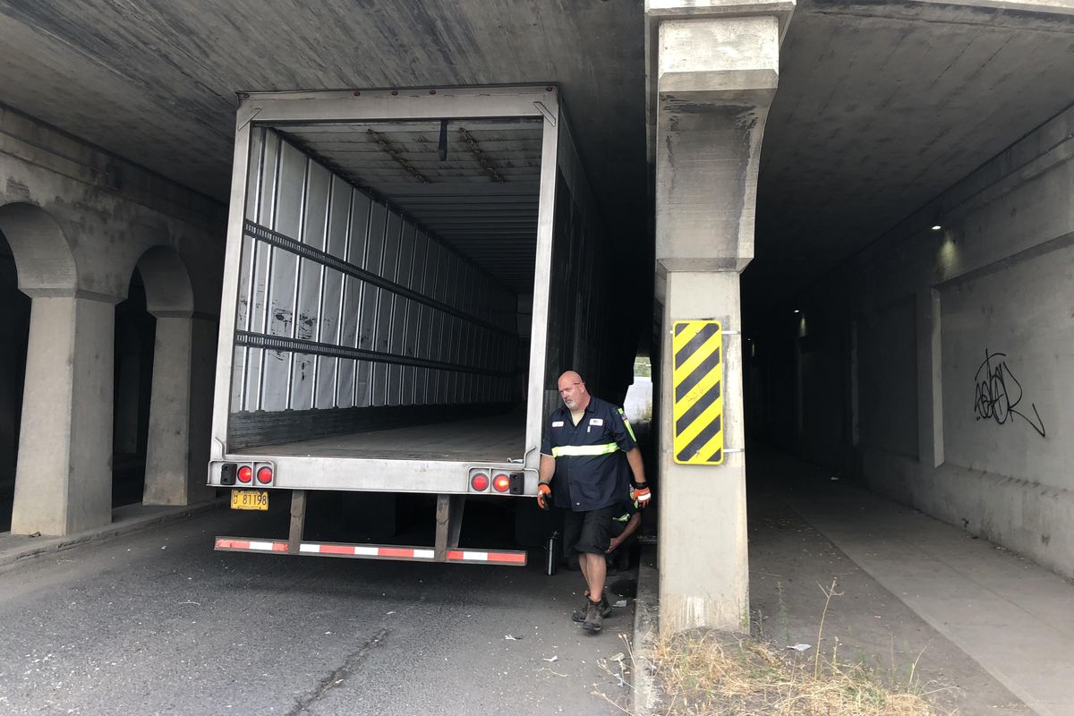 The driver of this truck stuck under a railroad overpass in Spokane’s East Central neighborhood Thursday said he thought he was one street over and took responsibility for the mishap. (Will Campbell / The Spokesman-Review)
