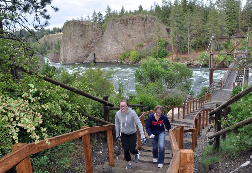 Riverside State Park visitors take advantage of the new steps leading up from the Bowl and Pitcher footbridge over the Spokane River. (Rich Landers)