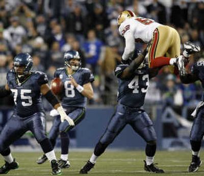 
Seattle's Leonard Weaver lifts 49er Jeff Ulbrich as he and Sean Locklear (75) block for QB Matt Hasselbeck.Associated Press
 (Associated Press / The Spokesman-Review)