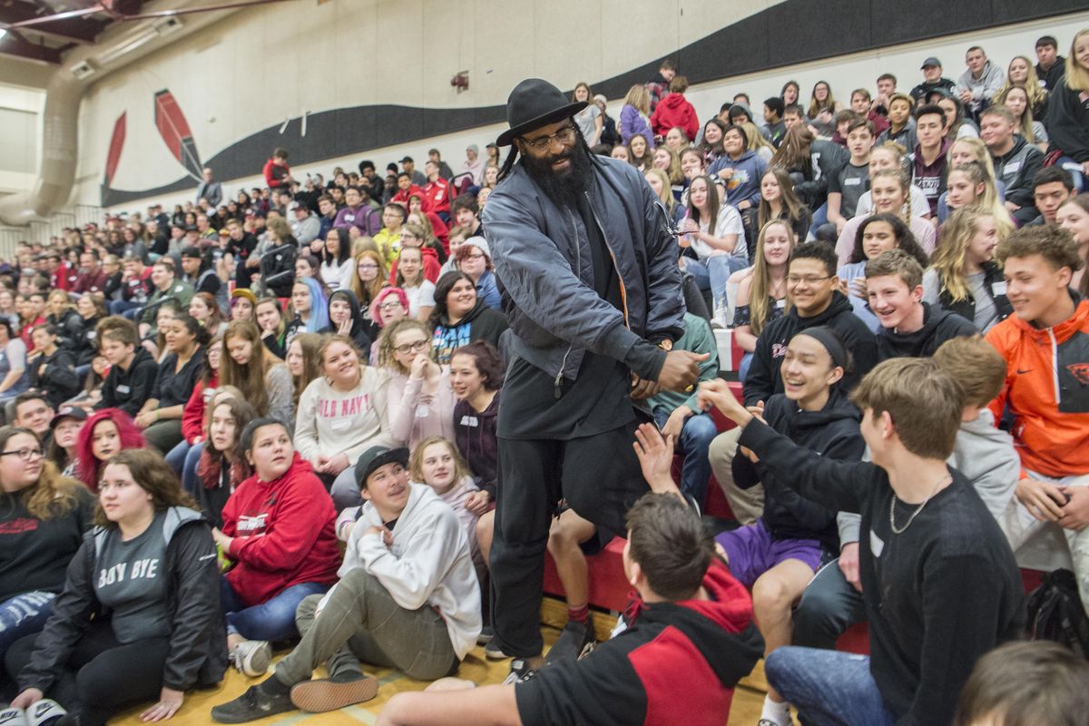 Former Gonzaga and NBA basketball player Rony Turiaf, center, greets students at North Central High School, Friday, April 13, 2018. North Central High students spent the day in activities to build community and make connections among students in response to a handful of suicides at the school. (Jesse Tinsley / The Spokesman-Review)