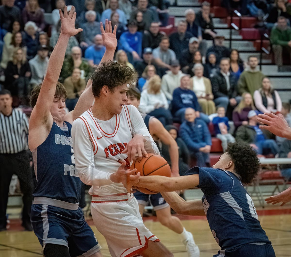 Gonzaga Prep guard Jayce Swanson fouls Ferris guard Dylan Skaife during Friday’s Greater Spokane League basketball game at Ferris High School.  (Colin Mulvany/The Spokesman-Review)