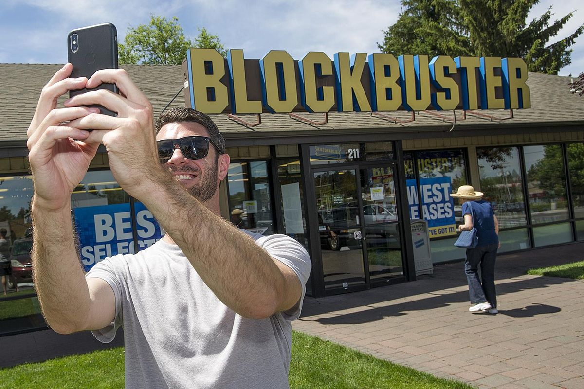 Scott Thornton takes a selfie in front of the Bend, Ore., Blockbuster on Friday, July 13, 2018. The Bend store will be the last remaining Blockbuster in operation in the United States after two stores in Alaska close Sunday. (Associated Press)