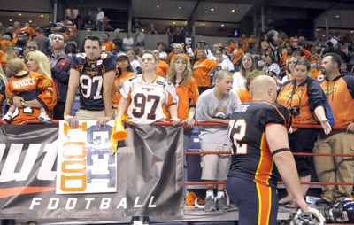 Spokane Shock No. 72 Kyle Young walks off the turf in front of dejected fans after losing the ArenaCup Championship game in the Spokane Arena Monday night.  (CHRISTOPHER ANDERSON / The Spokesman-Review)