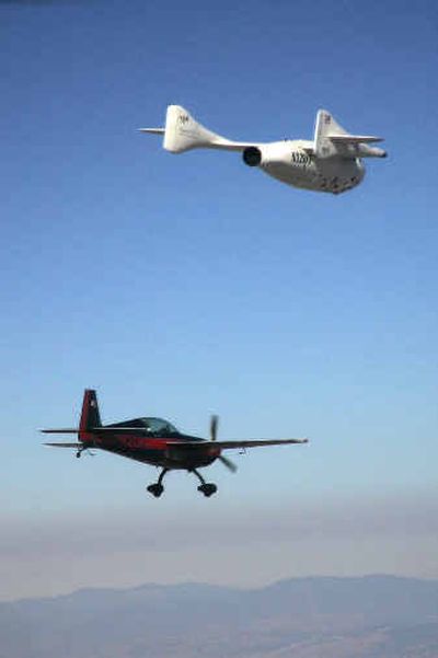 
A chase plane follows SpaceShipOne after it reached a height of 62 miles in the first nongovernmental flight to leave the Earth's atmosphere on Monday in Mojave, Calif. The space effort was funded by Microsoft co-founder Paul Allen. 
 (Getty Images / The Spokesman-Review)
