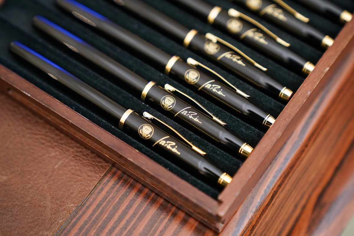 In this Jan. 21, 2021 photo, pens featuring President Joe Biden