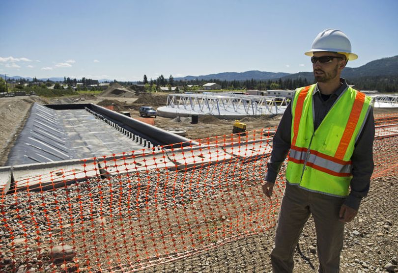 John Beacham speaks with the Press, Friday, about water reclamation facility upgrades including two flow equalization tanks, a solids storage hopper and a biofilter, seen left, to control odor. (Loren Benoit/Coeur d'Alene Press photo)