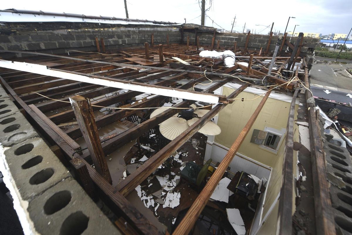 This Monday, Sept. 17, 2018 photo, shows the damaged roof of the Crush & Grind along the Carolina Beach Boardwalk in Carolina Beach, N.C. (Matt Born / Associated Press)