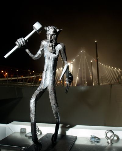 A troll stands by the Bay Bridge shortly before the bridge opened to traffic in San Francisco. The troll is meant to be a protector and good luck charm. (Associated Press)