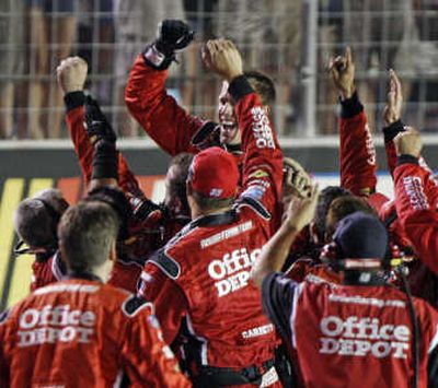 
Associated Press Carl Edwards, top, celebrates with his crew at the finish line after winning the NASCAR Nextel Cup Sharpie 500 auto race in Bristol, Tenn., Saturday.
 (Associated Press / The Spokesman-Review)