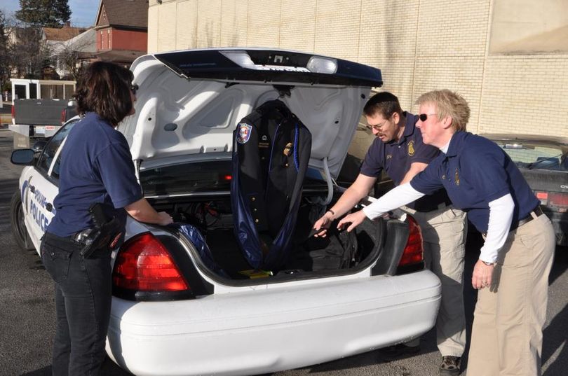 (from left) Spokane police Officers Shaney Redmon, Ron Tilley and Mylissa Coleman prepare to travel to Tacoma for a slain park ranger's memorial service. (Jennifer DeRuwe / Spokane Police Department)