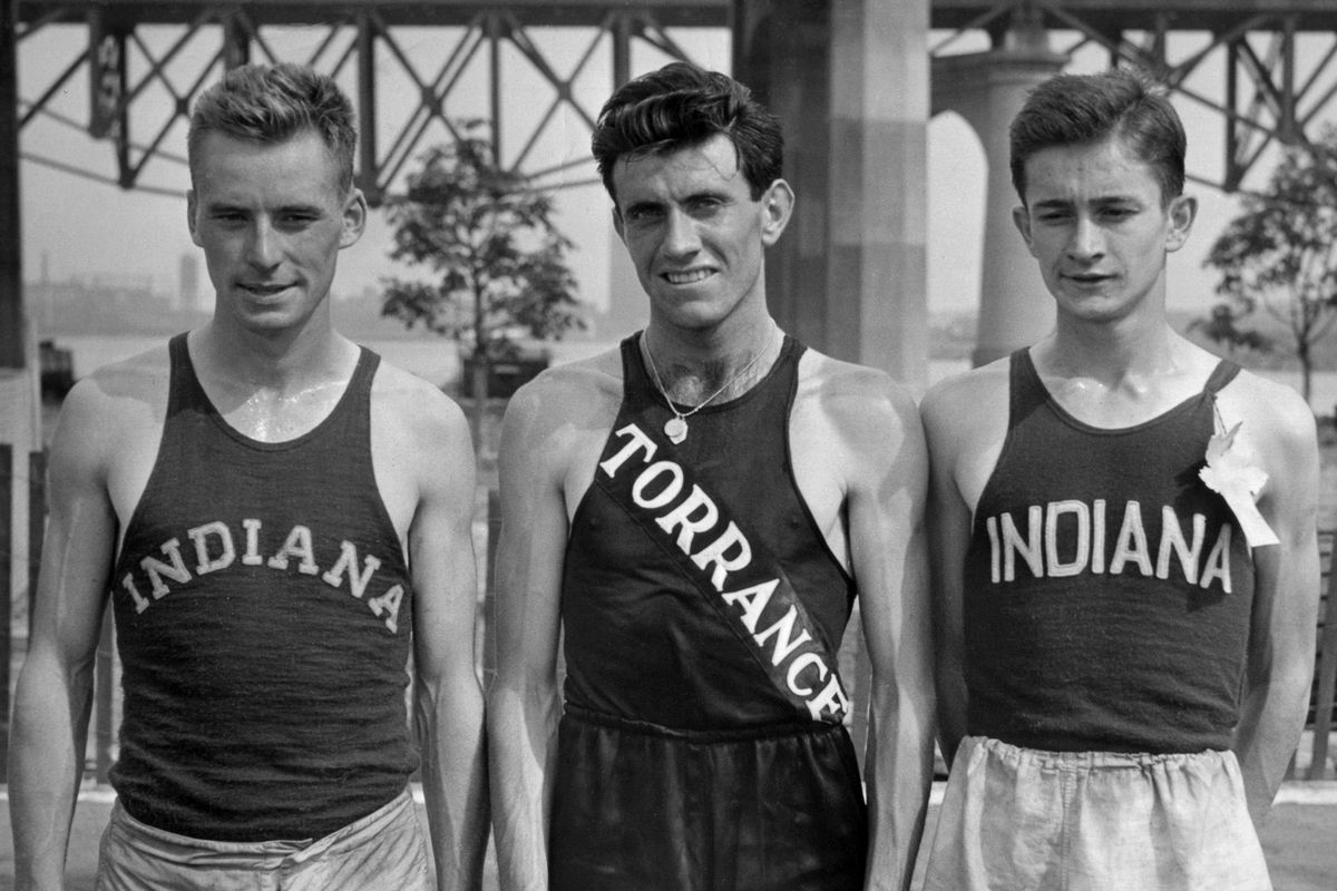 Louis Zamperini (center), pictured here in 1936, died from complications of pneumonia on Thursday. He was 97. (Associated Press)