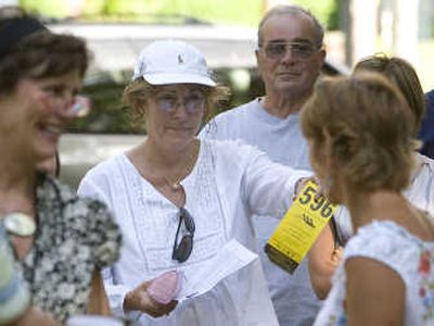 
Sylvia Davis, center, wins with a $7,000 bid on a home in Trenton during a recent auction in Ocean Township, N.J.  Associated Press
 (Associated Press / The Spokesman-Review)