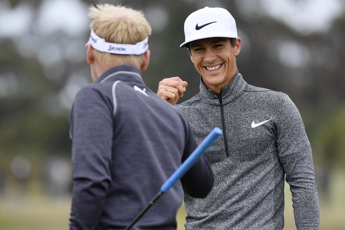 Denmark’s Thorbjorn Olesen, right, celebrates with teammate Denmark’s Soren Kjeldsen after a birdie putt on the fifth hole during their match at the World Cup of Golf at Kingston Heath in Melbourne, Australia, Saturday, Nov. 26, 2016. (Andrew Brownbill / Associated Press)