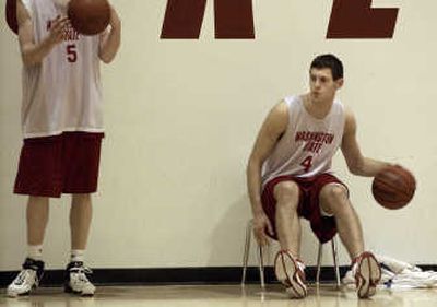 
Nikola Koprivica dribbles the ball between his legs as he watches Washington State's team practice on Wednesday. 
 (Brian Immel / The Spokesman-Review)