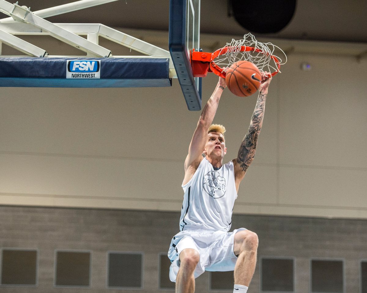 Micah Downs flushes in the first half of the Alumni Game in 2016.  (DAN PELLE/The Spokesman-Review)