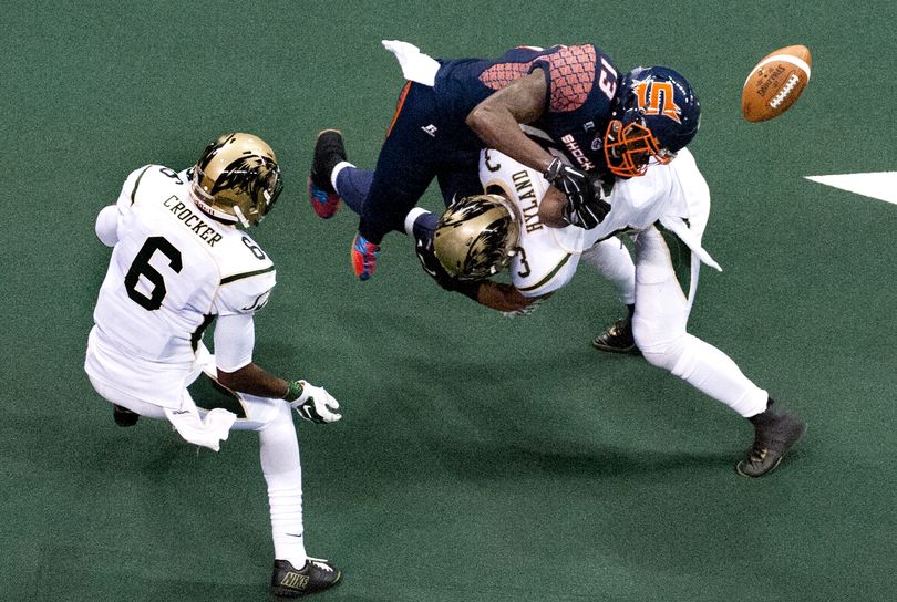 Spokane Shock's Rashaad Carter loses the ball after a hit from the San Jose SaberCats David Hyland. (Kathy Plonka)