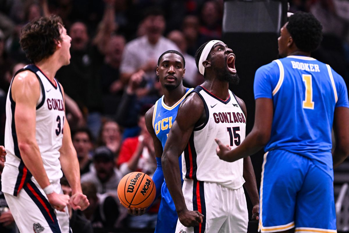 Gonzaga Bulldogs forward Graham Ike (15) celebrates with forward Braden Huff (34) after Ike dunked the ball against UCLA Bruins center Xavier Booker (1) and forward Eric Dailey Jr. (3) and draws a foul during the first half of a college basketball game on Saturday, Dec 13, 2025, at Climate Pledge Arena in Seattle, Wash. (Tyler Tjomsland/The Spokesman-Review)