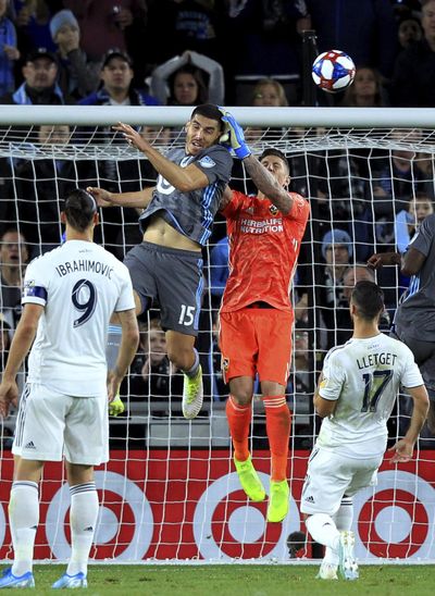 LA Galaxy goalkeeper David Bingham (1) deflects a header by Minnesota United defender Michael Boxall (15) during the first half of an MLS soccer first-round playoff match, Sunday, Oct. 20, 2019, in St. Paul, Minn. (Andy Clayton-King / Associated Press)