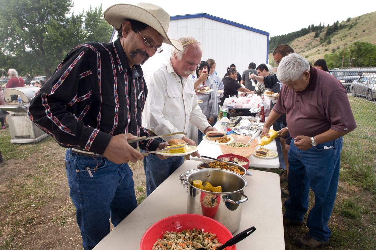 Val Drywater, grand marshal honoree, leads the way in the potluck line at Millpond Days community dinner in Nespelem on June 19.  The celebration is in its fifth year and honors Colville Indian Reservation residents who give back in many diverse ways. (Colin Mulvany / The Spokesman-Review)