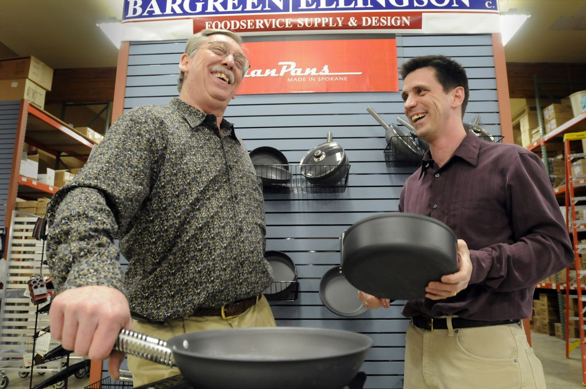 John Crow and son Rob Crow demonstrate their ManPan cookware. The pans, made of aluminum, have cool-to-the-touch handles and an anodized nonstick surface.  (Photos by JESSE TINSLEY / The Spokesman-Review)