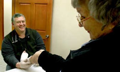 
Physician assistant Chris Sundquist works with Kay Johnson at his Athol office Wednesday. When Sundquist set up his office,  it was the first time in memory for many people in Athol they've been able to receive medical treatment in town.
 (Kathy Plonka / The Spokesman-Review)
