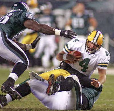 
Packers QB Brett Favre (4) is sacked by Eagles tackle Corey Simon as Derrick Burgess, left, closes in.
 (Associated Press / The Spokesman-Review)