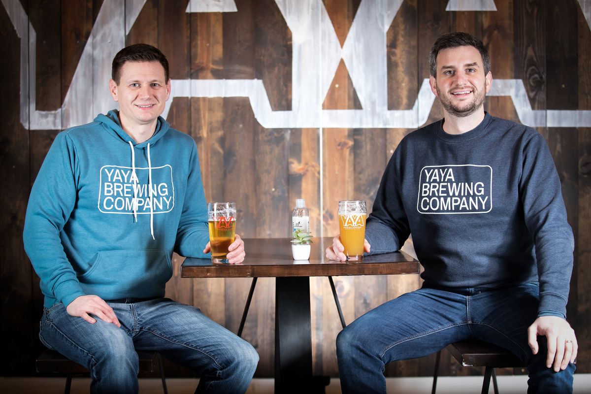 Brothers Chris and Jason Gass sit for a portrait in their taproom at YaYa Brewing Co. in Spokane Valley on Dec. 16, 2020. YaYa Brewing recently celebrated its first anniversary in business and is open for to-go orders at 11712 E. Montgomery Drive.  (Libby Kamrowski/The Spokesman-Review)
