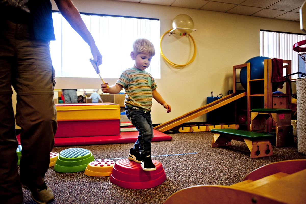Two-year-old Owen works on his balance at Joya Children & Family Developement in Spokane on Wednesday, April 10, 2019. Joya was formerly the Spokane Guilds' School & Neuromucsular Center. (Kathy Plonka / The Spokesman-Review)