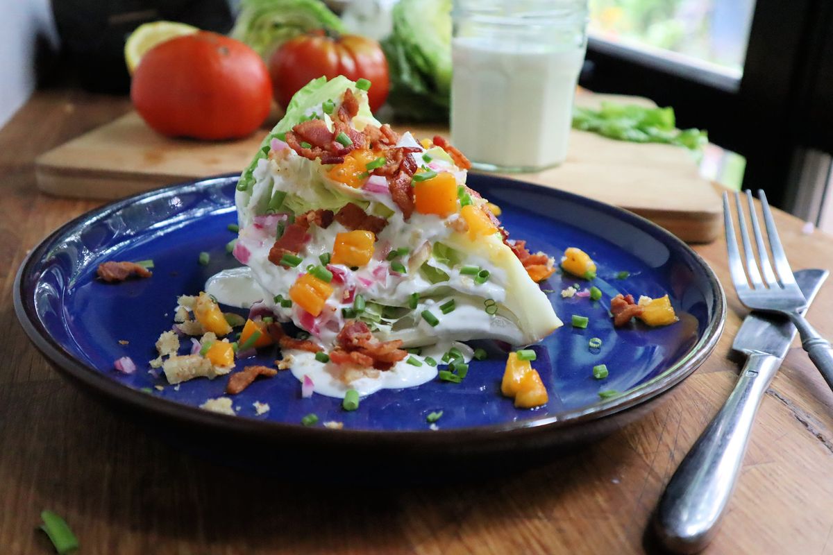 A towering iceberg wedge salad topped with crumble bacon and blue cheese dressing is a classic steakhouse side.  (Gretchen McKay/Pittsburgh Post-Gazette/TNS)